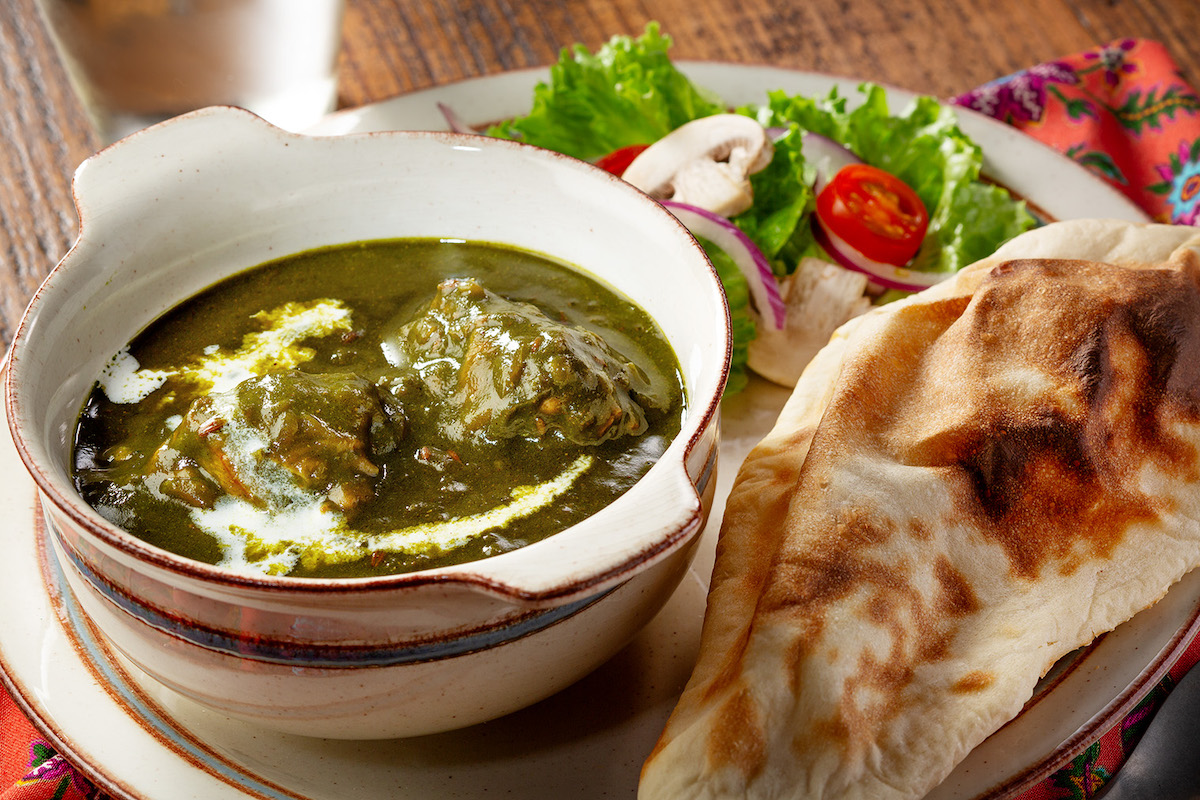 ほうれん草カレーにナンが添えられた写真